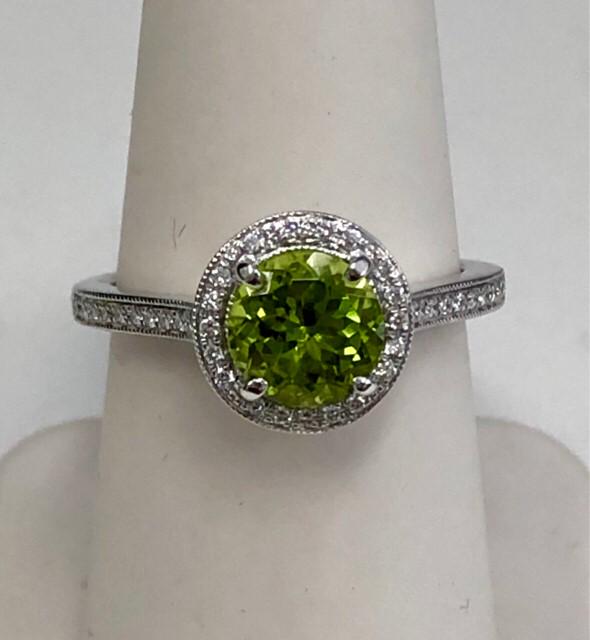 Peridot Round Halo Ring Mounting With Milgrained Round Bezel Gallery Accent In 14k White Gold (7mm): 14kw Ring 1rbpe=7mm 42rb=0.20ctw Size 5.75 Style: Halo Primary Stone: Peridot Gender: Ladies Metal:14K White Gold Country of Origin: China Dimensions (LxWxH in mm): 10.10X10.10X9.20 The BIDHAUS Guaran