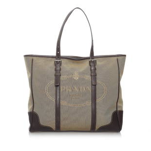 Prada Canapa Logo Canvas Tote Bag: Prada Canapa Logo Canvas Tote Bag This tote bag features a canvas body with leather trim flat handles a top zip closure and an interior zip and slip pockets. Brand: Prada Model: Canapa Logo