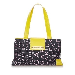 Bvlgari Logomania Canvas Tote Bag: Bvlgari Logomania Canvas Tote Bag This tote bag features a canvas body with leather trim a flat leather strap a front flap with a magnetic closure and interior zip and slip pockets. Brand: