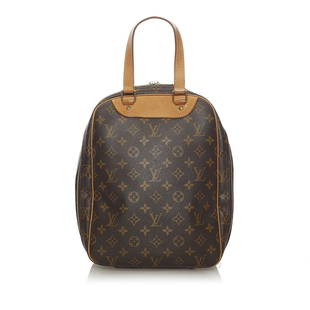 Louis Vuitton Monogram Excursion: Louis Vuitton Monogram Excursion The Excursion features a monogram canvas body flat vachetta handles vachetta trim a zip around closure and an interior slip pocket. Brand: Louis Vuitton Model: