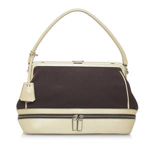 Prada Canvas Handbag: Prada Canvas Handbag This handbag features a canvas body exterior zip around pocket rolled leather handles magnetic closure and interior zip pocket. Brand: Prada Model: Canvas Handbag Origin: