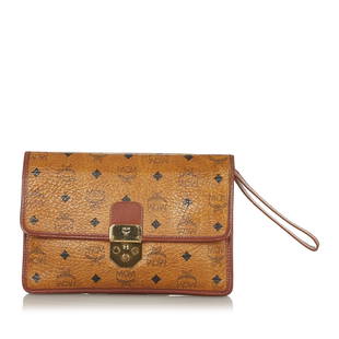 MCM Visetos Leather Clutch Bag: MCM Visetos Leather Clutch Bag This clutch bag features a leather body and a top flap with push lock closure. Brand: MCM Model: Visetos Leather Clutch Bag Origin: Germany Category: Bags Color: