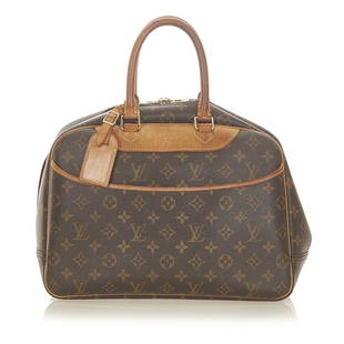 Louis Vuitton Monogram Deauville: Louis Vuitton Monogram Deauville The Deauville features a monogram canvas body an exterior front slip pocket rolled leather handles a top zip closure and an interior open pockets. Brand: Louis