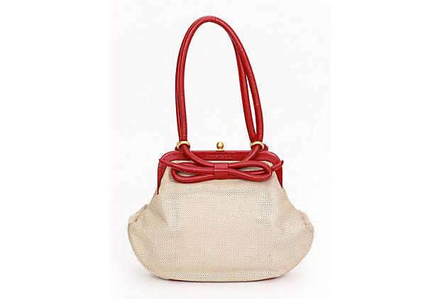 Chanel Beige & Red Perforated Bow Bag: Chanel Beige & Red Perforated Bow Bag Condition: Very Good; minor scratch on the front bow. Era: Contemporary; 1990s Dimensions: 11" L x 2" W x 8" H Materials: leather metal Color: beige red gold Chan