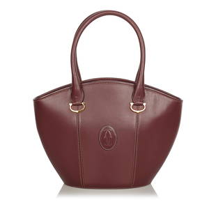 Must de Cartier Leather Handbag: Must de Cartier Leather Handbag This handbag features a leather body rolled leather handles a top zip closure and interior zip and slip pockets. Brand: Cartier Model: Must de Cartier Leather