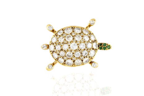 Diamond Turtle Brooch: Diamond Turtle Brooch Turtle brooch. finely crafted in 18 k yellow gold with brilliant cut diamonds weighing a total of approximately 9.00 carat and round cut emeralds on the head. The BIDHAUS