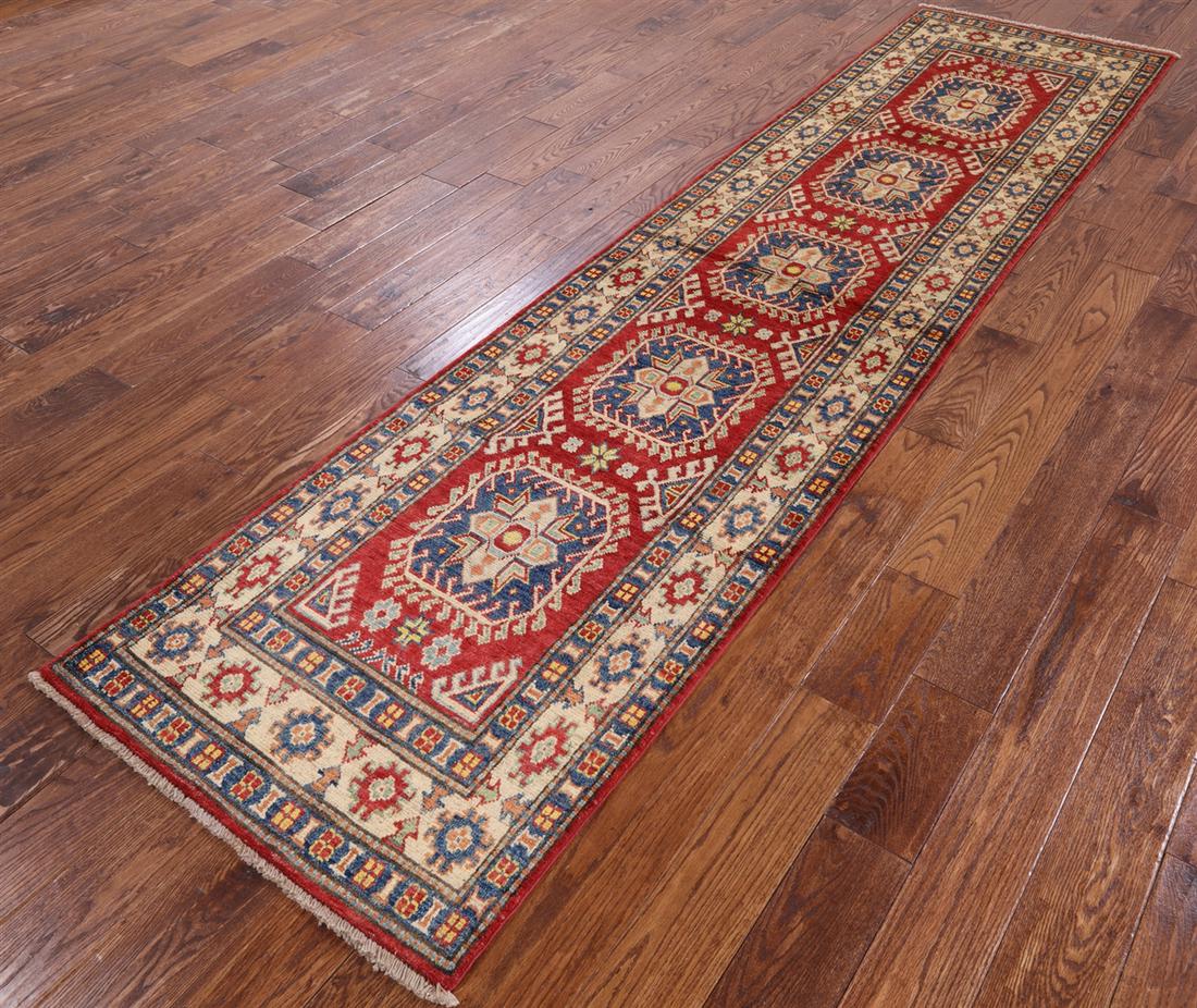 Clearance 2' 8" X 11' 0" Runner Kazak Hand Knotted Wool Rug: Clearance 2' 8" X 11' 0" Runner Kazak Hand Knotted Wool Rug Design: Traditional Exact Size: 2\ 8 X 11\ 0 Style: Kazak Foundation: Cotton Pile: Wool Weave: Hand-knotted Age: New The BIDHAUS Guarantee: