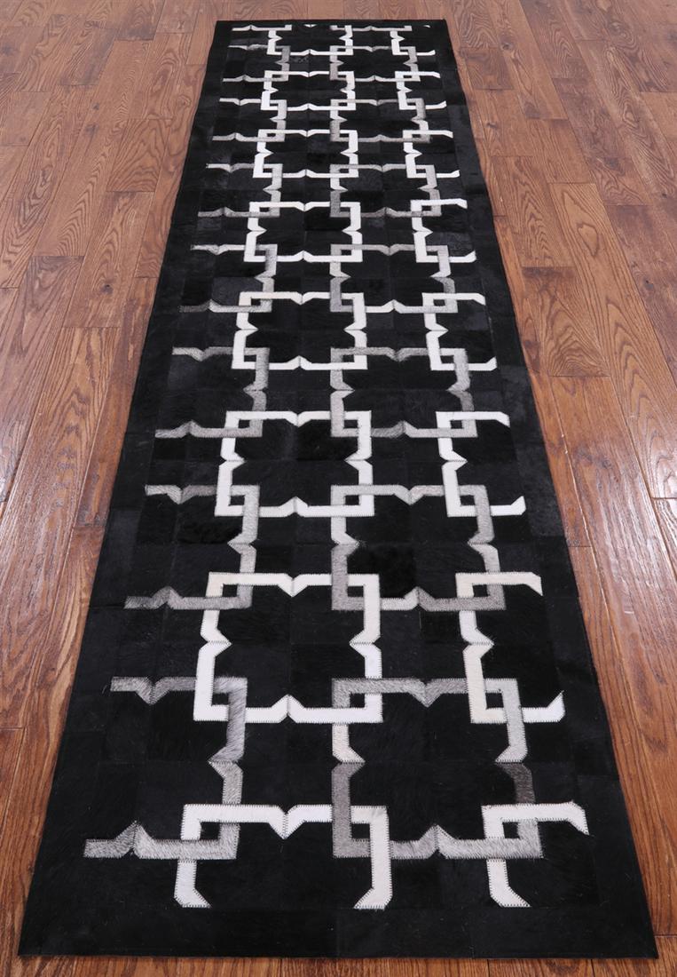 Hand Stitched Cowhide Runner Rug 2' 6" X 10' 0": Hand Stitched Cowhide Runner Rug 2' 6" X 10' 0" Material: Organic Natural Cowhide Exact Size: 2\ 6 X 10\ 0 Age: New The BIDHAUS Guarantee: All items in this auction are guaranteed authentic and come w