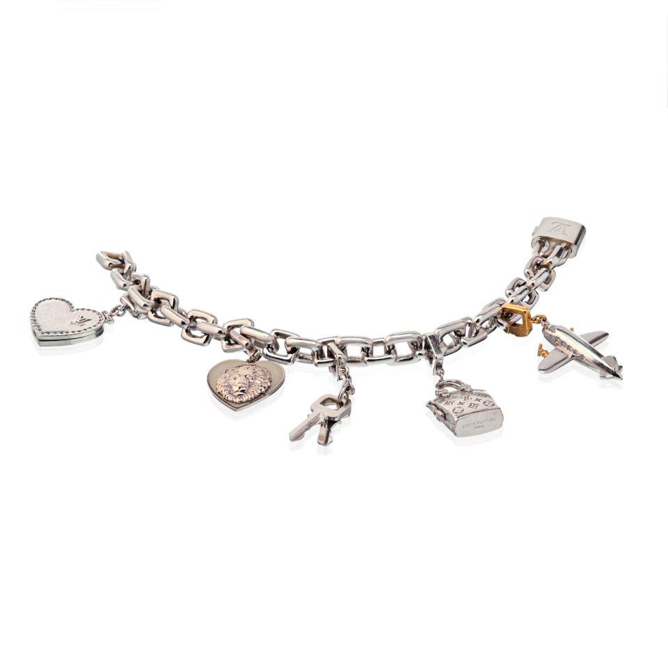 Louis Vitton 18K White Gold Six Charm Bracelet: Louis Vitton 18K White Gold Six Charm Bracelet Type: Bracelets Metal: 18K White Gold Grams: 141 Measurements: Length: 6-3/4 inches Condition: Excellent. Signed By: Louis Vuitton Brand: Louis Vitton Ot