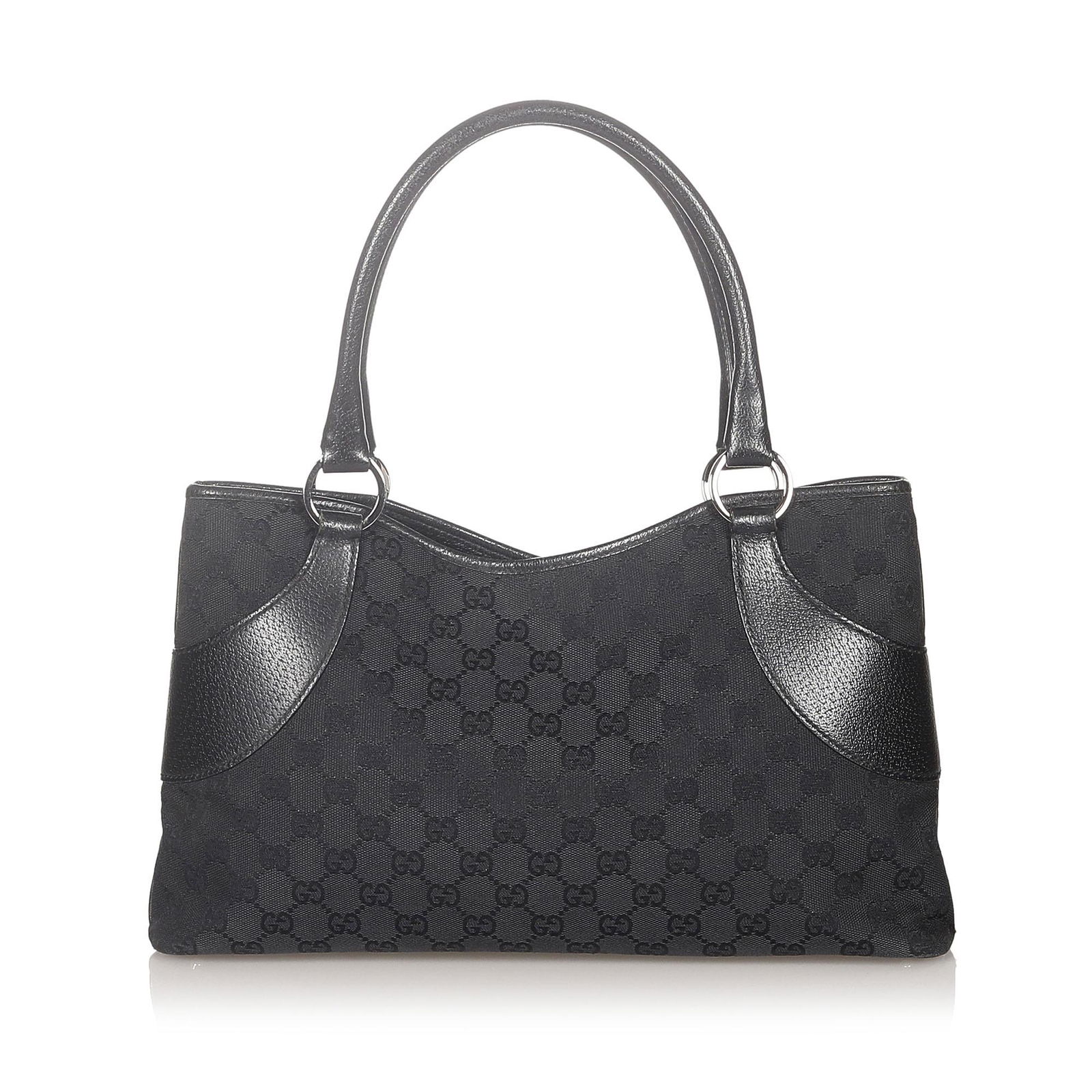 Gucci GG Canvas Tote Bag: Gucci GG Canvas Tote Bag This tote bag features a canvas body with leather trim rolled leather strap an open top with a magnetic snap closure and an interior zip pocket. Brand: Gucci Model: GG Canvas
