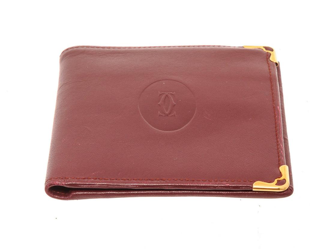 Cartier Burgundy Two Fold Wallet: Cartier Burgundy Two Fold Wallet Cartier Burgundy Two Fold Wallet with\xa0gold-tone\xa0hardware trim leather interior card holder pocket leather\xa0lining\xa0and flap\xa0closure. The BIDHAUS Guarantee