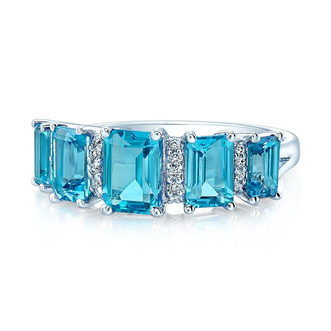 Swiss Blue Topaz 5 Stone & Diamond Emerald Cut Ring In 14k White Gold: Swiss Blue Topaz 5 Stone & Diamond Emerald Cut Ring In 14k White Gold This Elegant 5 Stone Emerald Cut Swiss Blue Topaz Ring Is Exquisitely Set In A 14k White Gold Setting Beautifully Highlighted By S