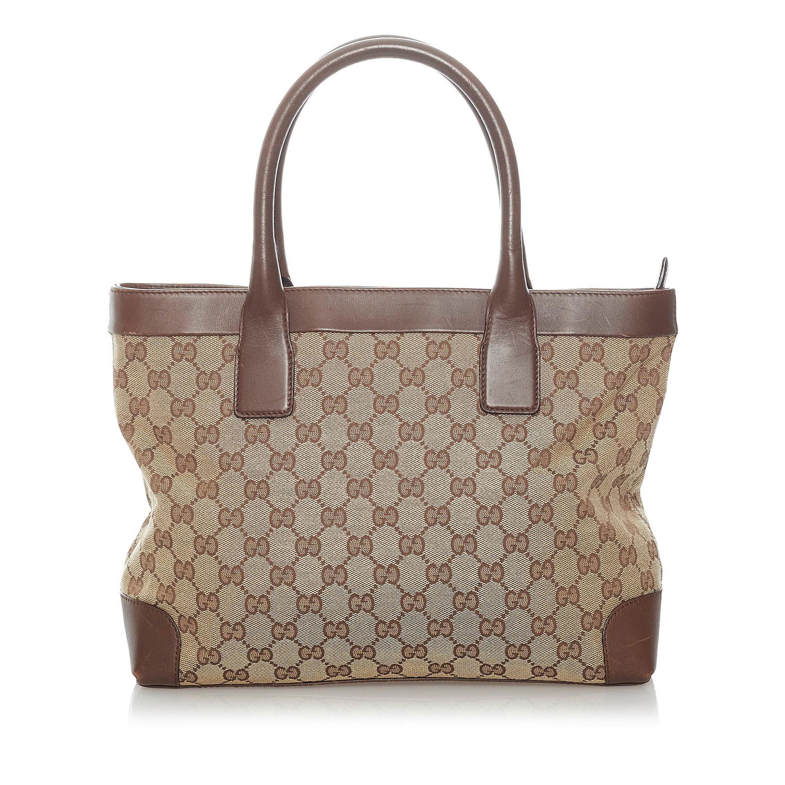 Gucci GG Canvas Handbag: Gucci GG Canvas Handbag This handbag features a canvas body with leather trim rolled leather straps an open top and an interior zip pocket. Brand: Gucci Model: GG Canvas Handbag Origin: Italy Category