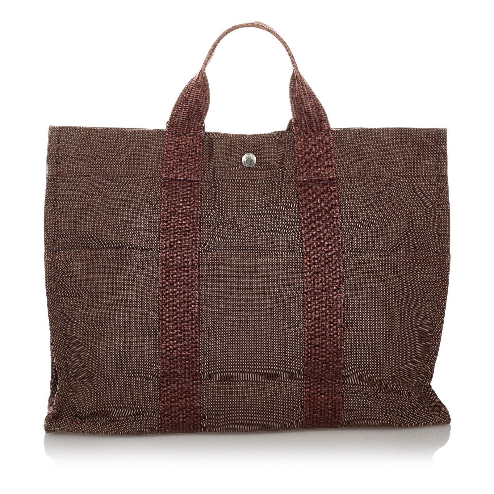 Hermes Fourre Tout MM: Hermes Fourre Tout MM The Fourre Tout MM tote features a canvas body exterior front and back slip pockets flat handles an open top with a snap closure and an interior zip compartment. Brand: Hermes Mo