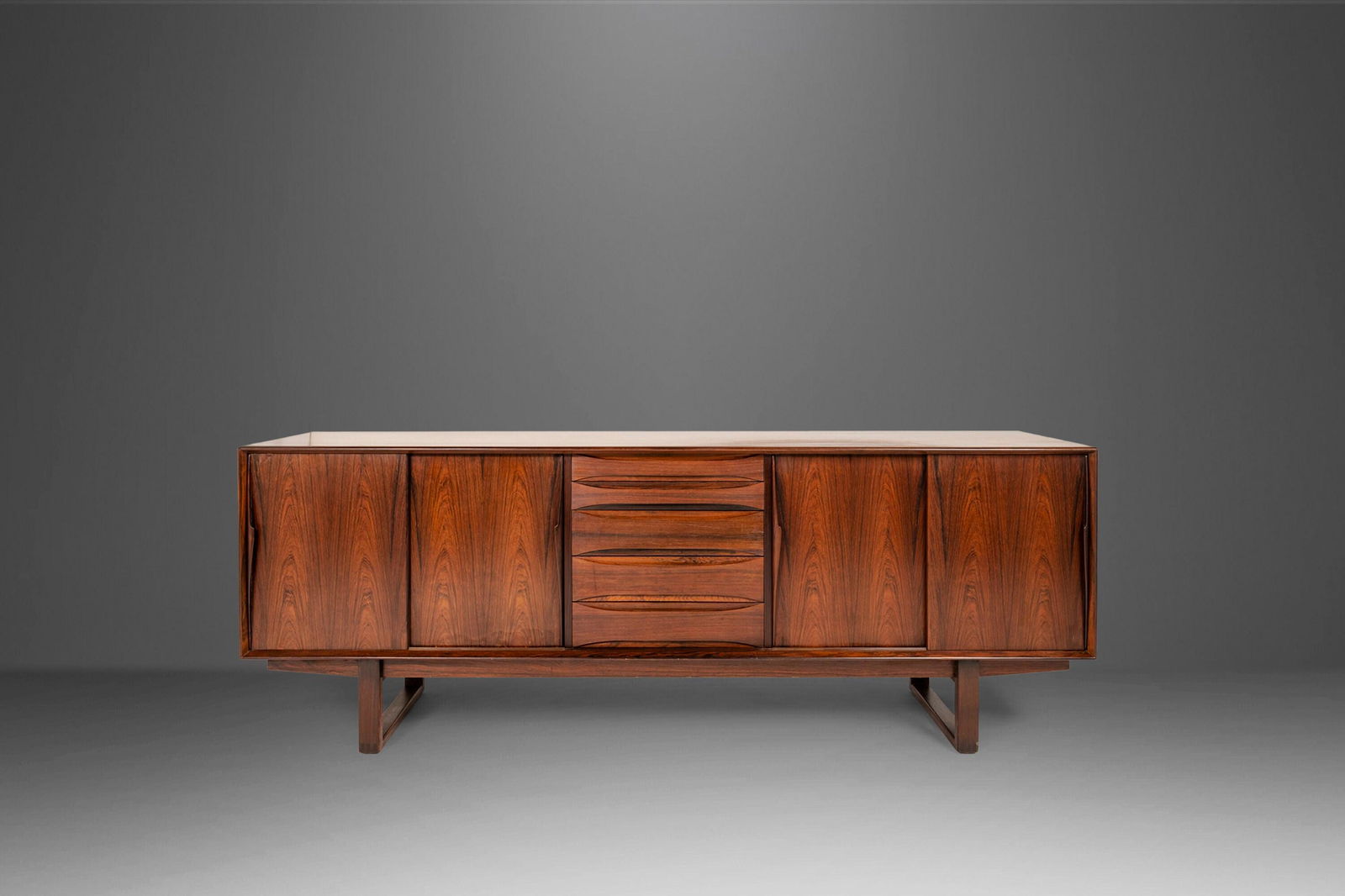 Danish Modern Rosewood Credenza Set on a Sled Base Attributed to Arne Vodder Denmark 1960s: Danish Modern Rosewood Credenza Set on a Sled Base Attributed to Arne Vodder Denmark 1960s Danish Modern Rosewood Credenza Set on a Sled Base Attributed to Arne Vodder Denmark 1960s About: Equal parts