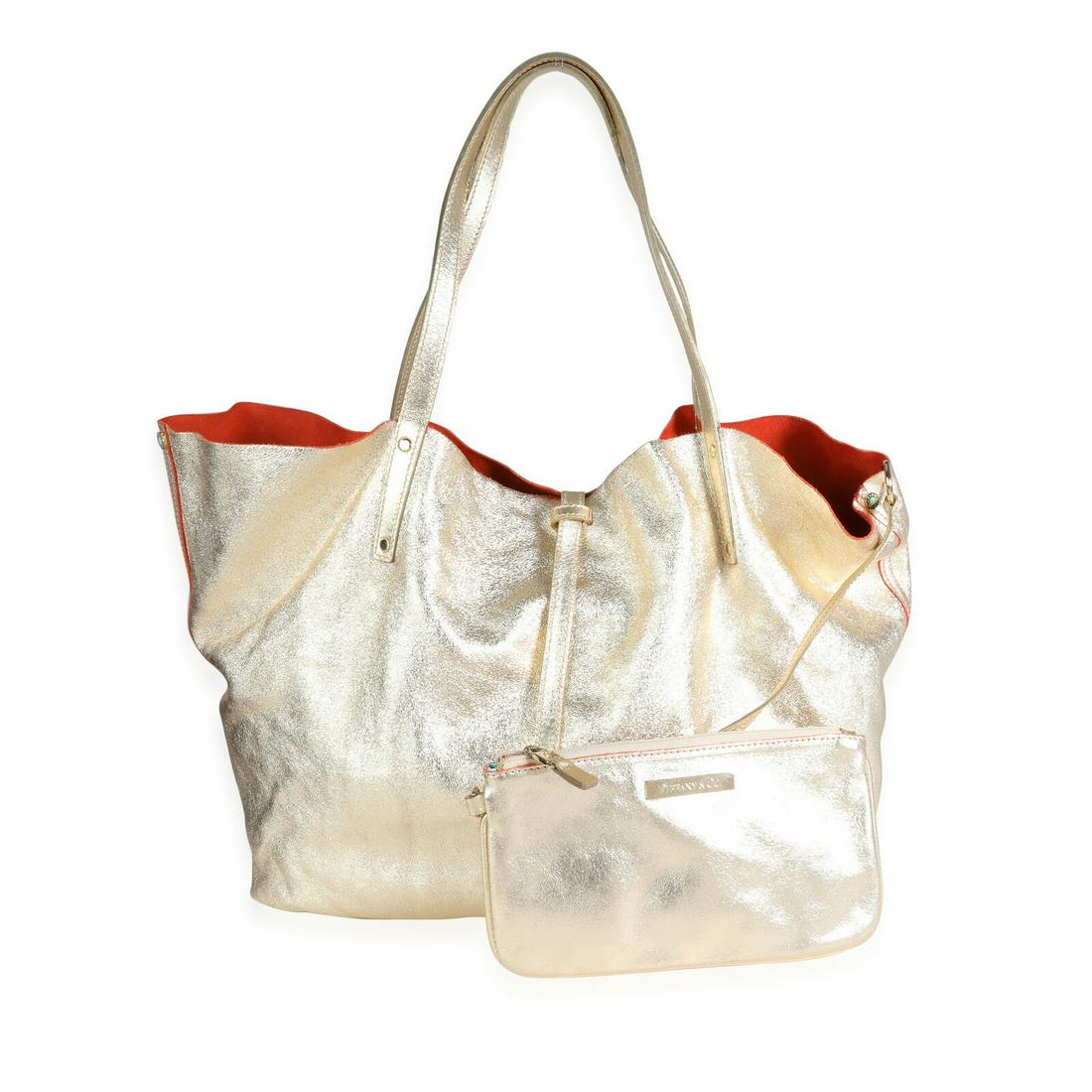 Tiffany & Co. Gold Metallic Leather & Orange Suede Reversible Tote: Tiffany & Co. Gold Metallic Leather & Orange Suede Reversible Tote Dimensions: 21 x 15 x 5 Handbag Accessories: Dustbag;Pochette;Care Booklet Bag Length: 21 in Bag Depth: 5 in Bag Height: 15 in Style: