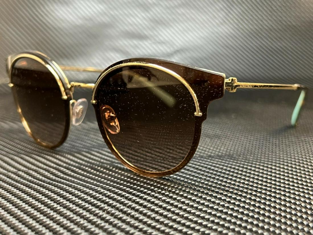 Tiffany TF3061 60553B Pale Gold Women's Round Sunglasses 64 mm: Tiffany TF3061 60553B Pale Gold Women's Round Sunglasses 64 mm Brand: Tiffany & Co. Type: Sunglasses Frame Color: Gold Style: Round Lens Color: Brown Features: Lightweight Lens Technology: Gradient Fr