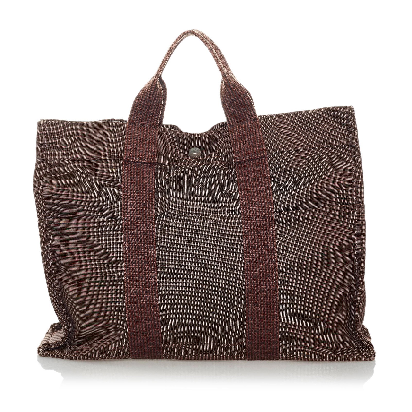 Hermes Herline MM: Hermes Herline MM The Herline MM tote bag features a canvas body exterior front and back slip pockets flat handles an open top with a snap closure and an interior zip compartment. Brand: Hermes Model: