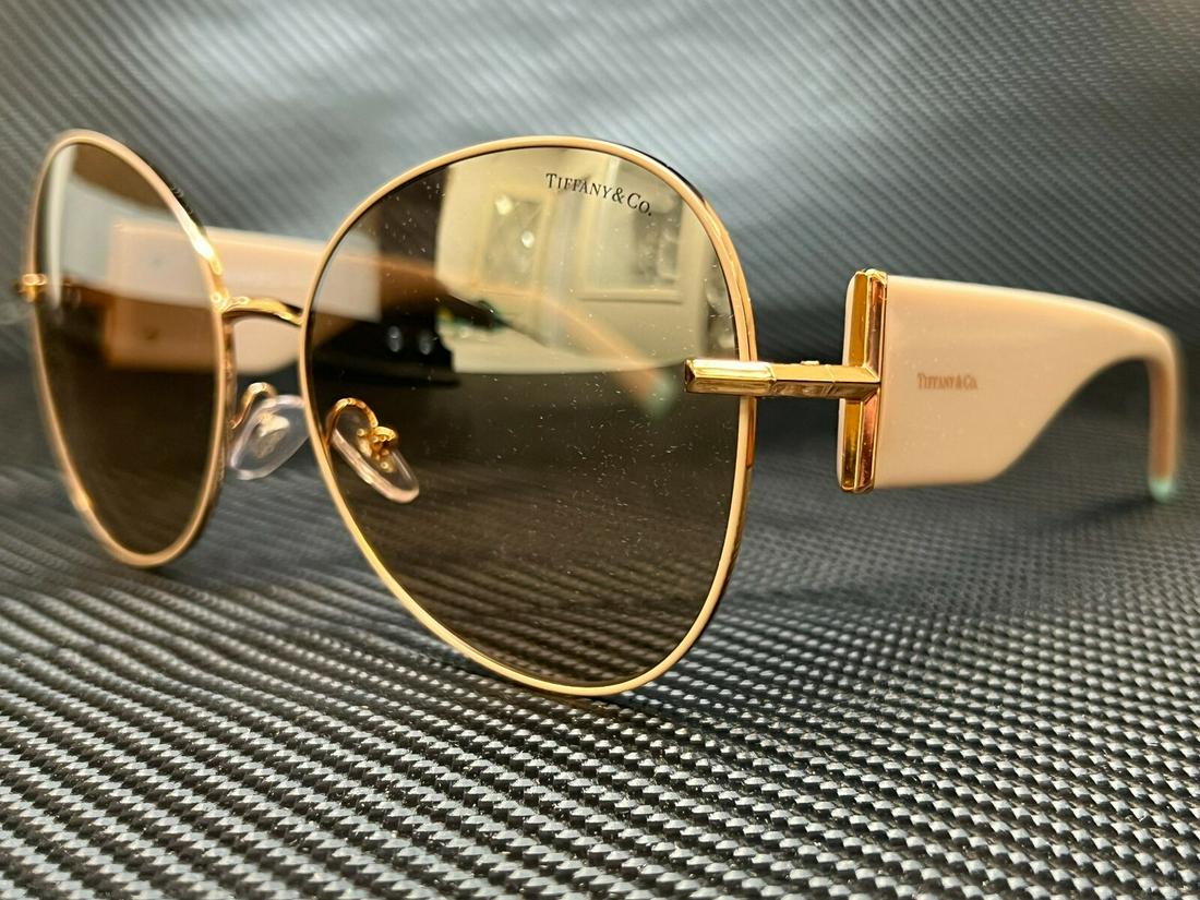 TIFFANY TF3069 61483D Gold Brown Mirror Women's Sunglasses 59 mm: TIFFANY TF3069 61483D Gold Brown Mirror Women's Sunglasses 59 mm Brand: Tiffany & Co. Type: Sunglasses Frame Color: Gold New The BIDHAUS Guarantee: All items in this auction are guaranteed to be 100% 