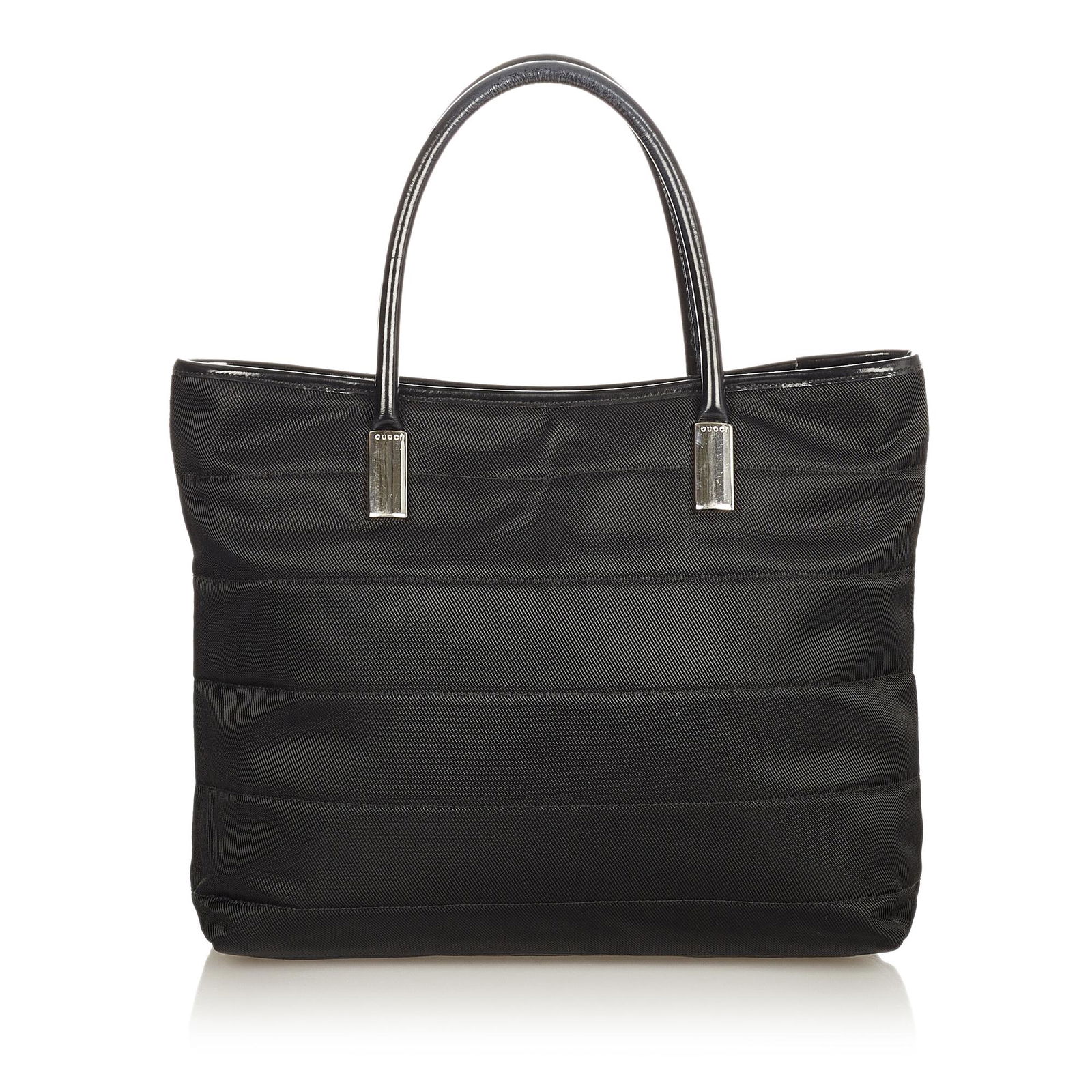 Gucci Nylon Handbag: Gucci Nylon Handbag This handbag features a nylon body metal handles open top with magnetic snap button closure and an interior zip pocket. Brand: Gucci Model: Nylon Handbag Origin: Italy Category: Ba