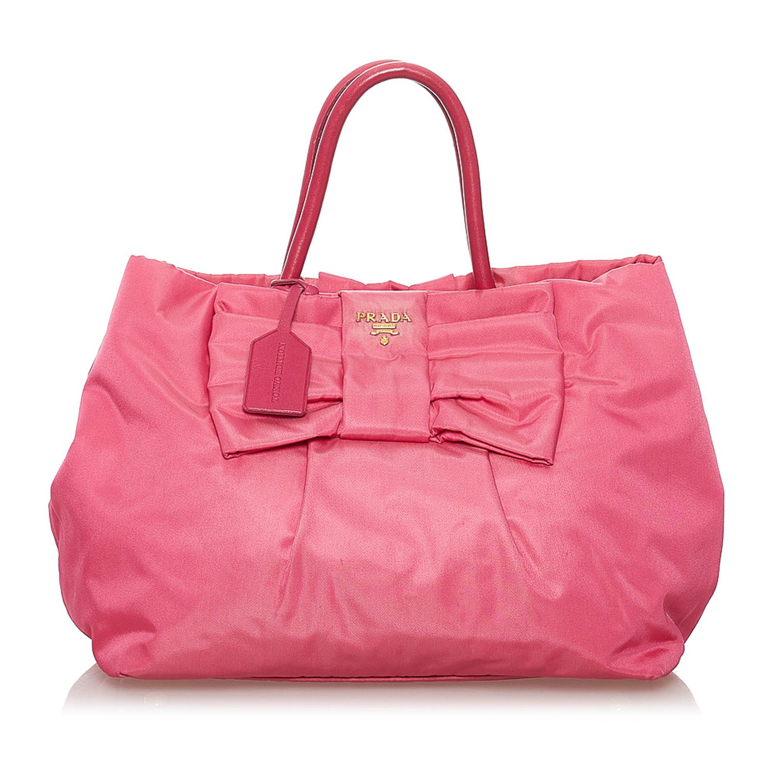Prada Fiocco Bow Tessuto Tote Bag: Prada Fiocco Bow Tessuto Tote Bag This tote bag features a nylon body with ribbon detail rolled leather handles an open top with a magnetic snap button closure and an interior zip pockets. Brand: Prad