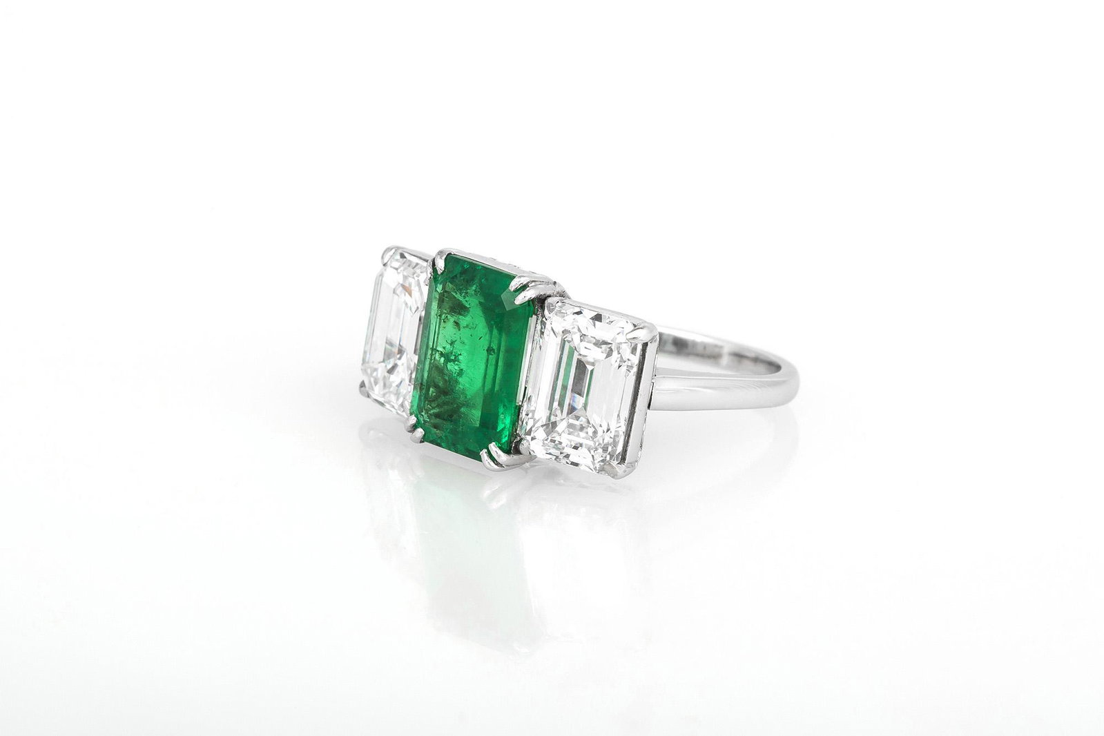 Emerald Cut Green Emerald & Diamond Ring: Emerald Cut Green Emerald & Diamond Ring This 14K white gold ring features a vibrant green Colombian Emerald at the center measuring 10.73 x 7.84 x 4.26mm and totaling 2.61 carats. Emerald cut Diamond