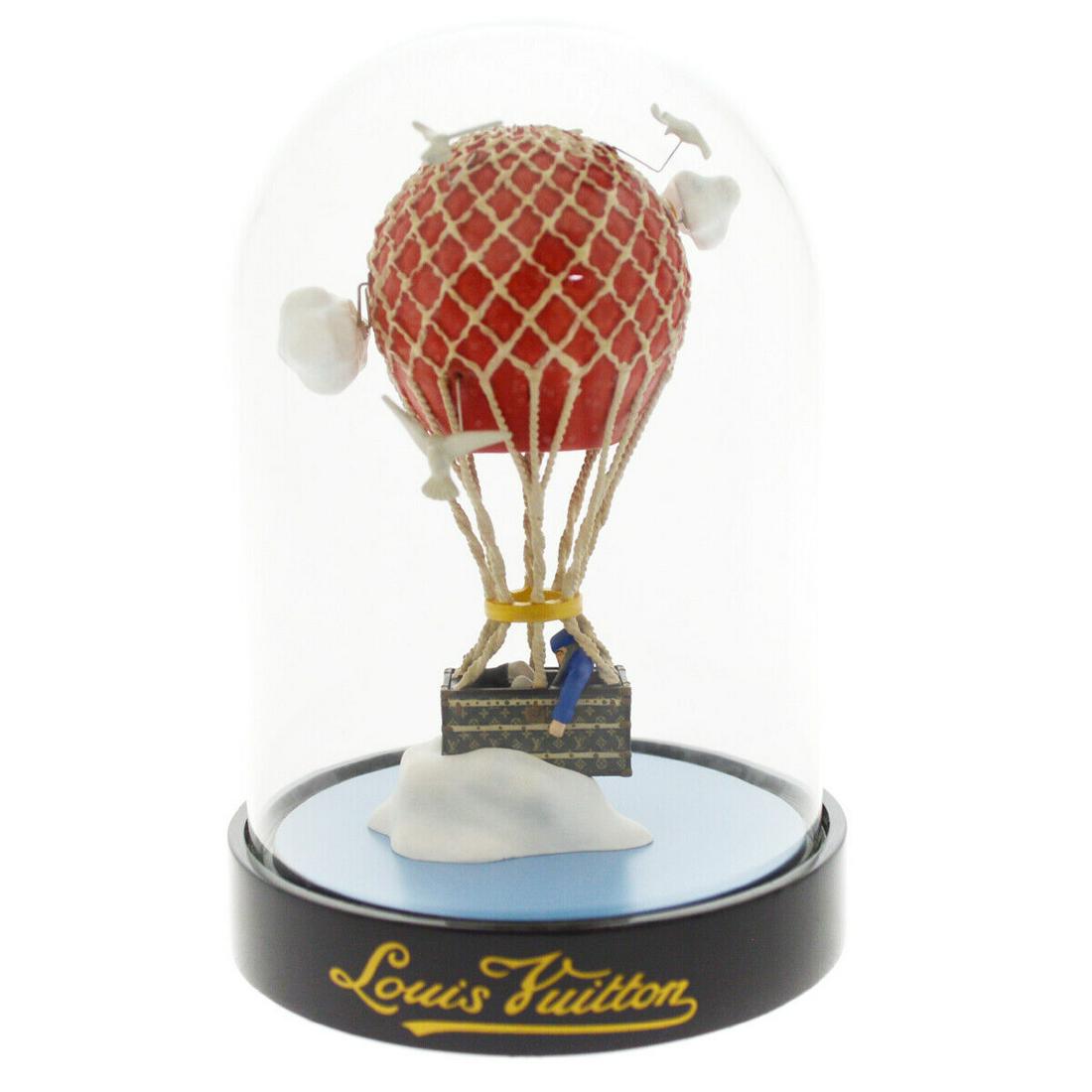 LOUIS VUITTON MAR ARO AIR BALLOON SNOW GLOBE DOME OBJECT NOVELTY: LOUIS VUITTON MAR ARO AIR BALLOON SNOW GLOBE DOME OBJECT NOVELTY Type: Snowdome Color: Clear Black Brand: Louis Vuitton Outside Condition: C: Heavily Used/Inside Condition: C: Heavily Used The BIDHAUS