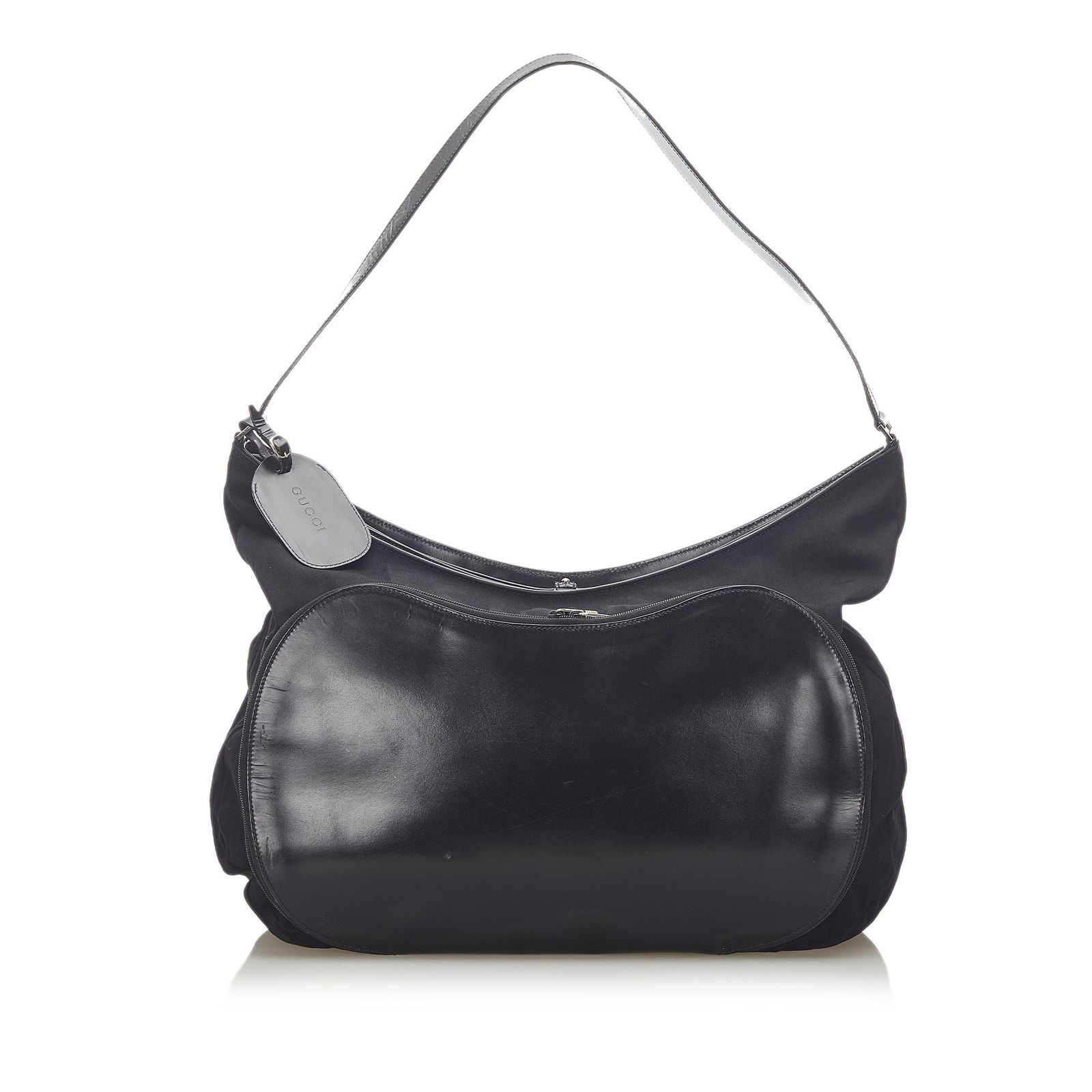 Gucci Nylon Travel Bag: Gucci Nylon Travel Bag This travel bag features a nylon body with leather trim an exterior front zip pocket a flat leather strap a top zip closure and an interior zip pocket. Brand: Gucci Model: Nylon