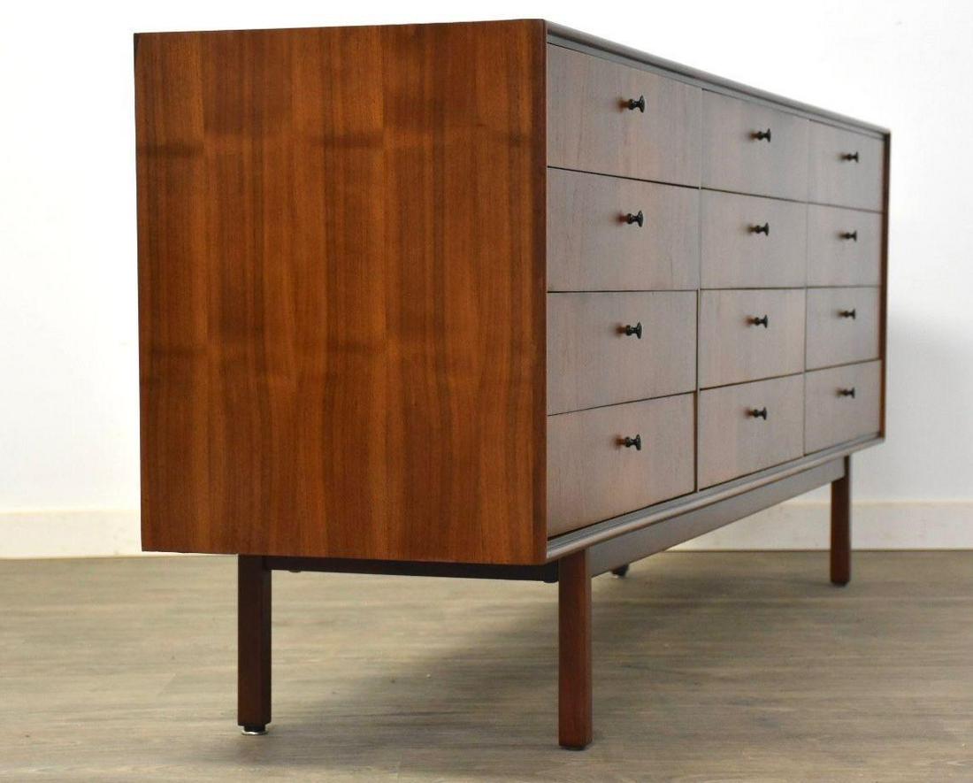 Jack Cartwright for Founders Walnut Dresser: Jack Cartwright for Founders Walnut Dresser A beautiful mid century modern walnut case twelve drawer dresser designed by Jack Cartwright for Founders Furniture featuring black knobs. Often times attri