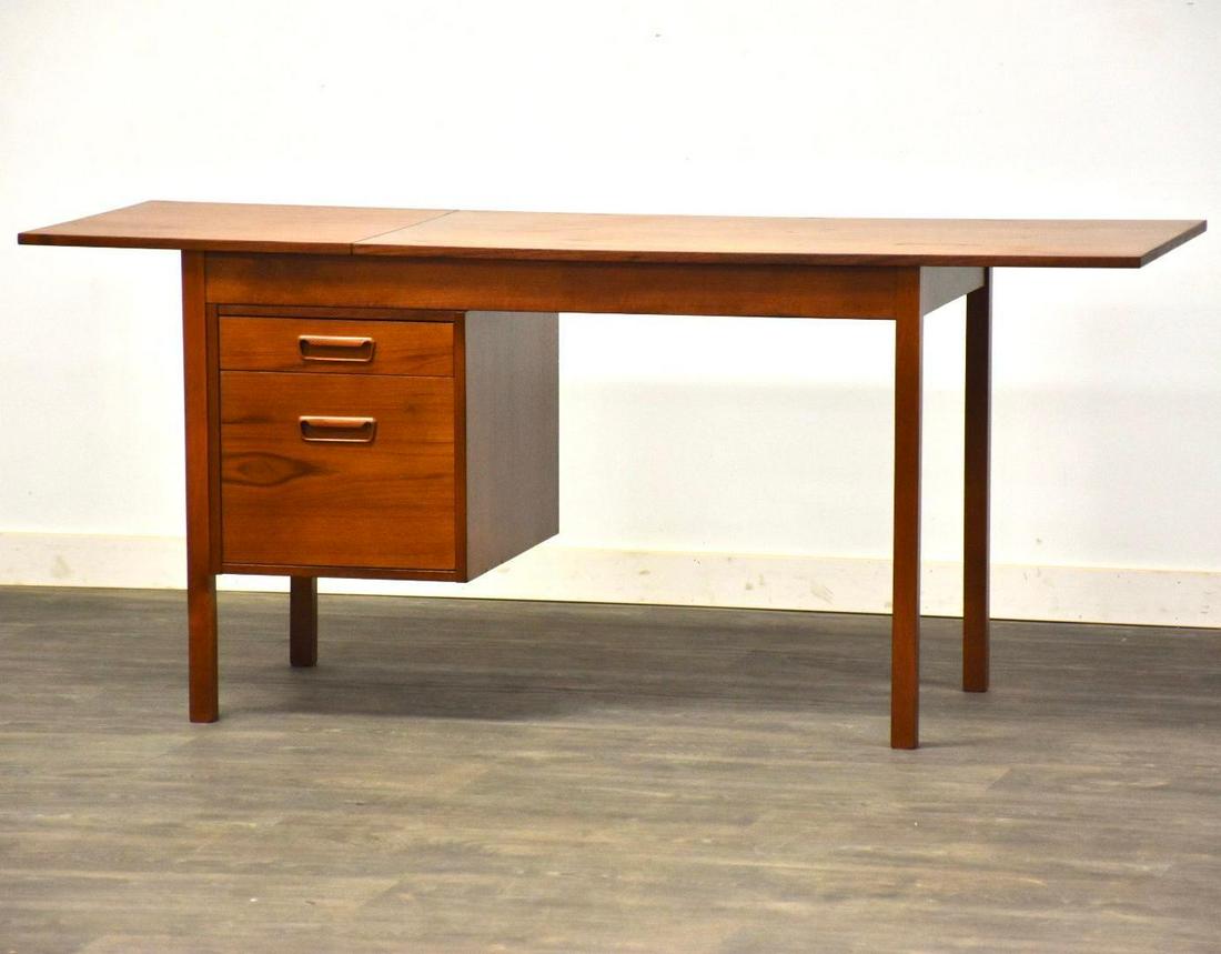 Danish Modern Teak Drop Leaf Desk: Danish Modern Teak Drop Leaf Desk A mid century modern teak desk in the style of Arne Vodder with a single drop leaf which when extended extends the desk to 65". One drawer capable of holding files. F