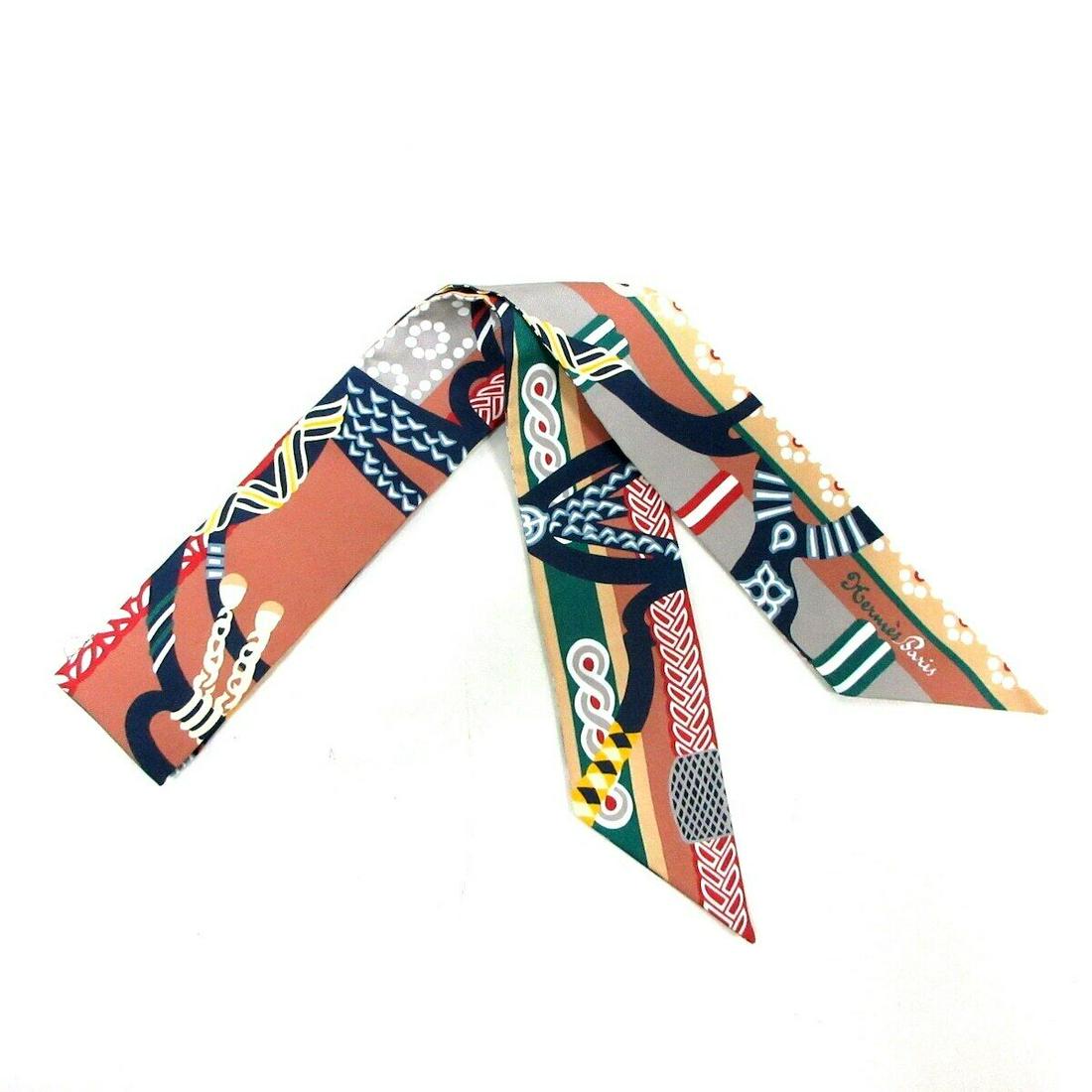 HERMES Twilly - Brown Multi Scarf: HERMES Twilly - Brown Multi Scarf Style: Scarf Color: Brown Multi Product Name: Twilly Accessories: Box Paper Tag Type: Scarf A: Excellent The BIDHAUS Guarantee: All items in this auction are guarante