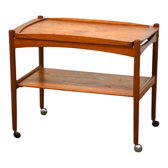 Poul Hundevad Teak Serving Cart: Poul Hundevad Teak Serving Cart A mid century modern teak serving bar cart designed by Poul Hundevad with a removable tray and rolling casters. Made in Denmark. 29" wide. 17" deep. 23.5" tall. Dimensi