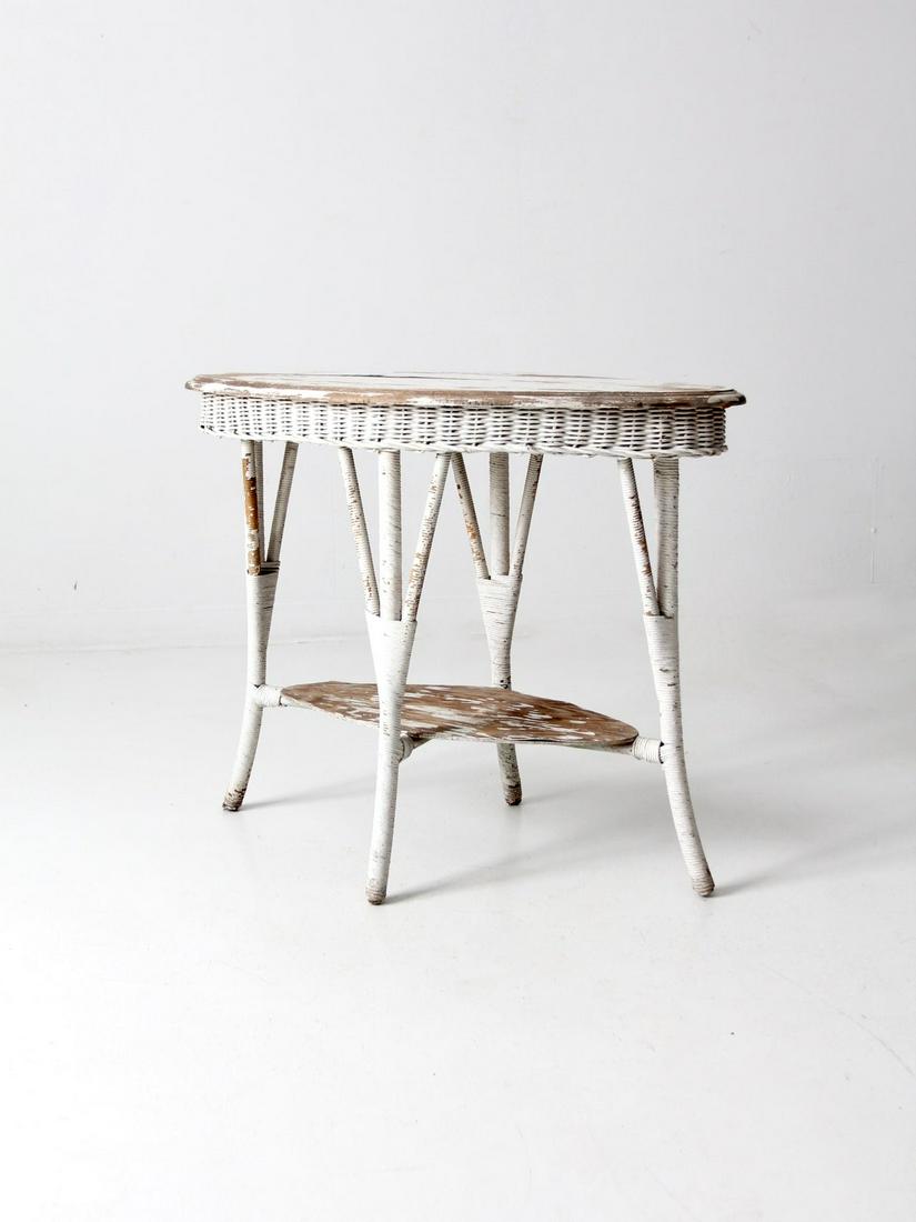 Antique White Wicker Side Table: Antique White Wicker Side Table This is an antique wicker accent table. The white wood top table features a wicker apron and wicker wrapped legs. A shabby chic beauty with wonderfully worn paint the o