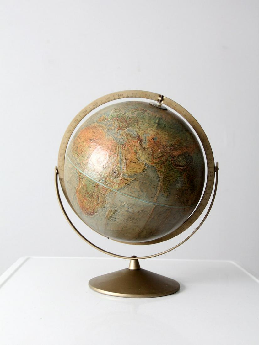 Mid-Century Replogle Globe: Mid-Century Replogle Globe This is a vintage Replogle globe dating 1968 - 1970. The 12 inch "Land and Sea" tabletop globe has a gold tone metal base and meridian with a lovely blue-green tone map. Hei