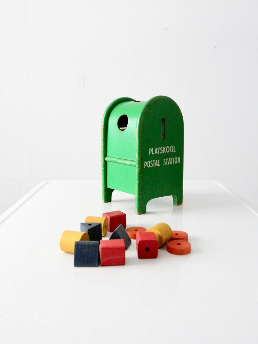 Mid-Century Playskool Postal Toy: Mid-Century Playskool Postal Toy This is a mid-century Playskool toy. The Postal Station block toy features a green mailbox with different shaped holes to place the differently shaped blocks. A flip d