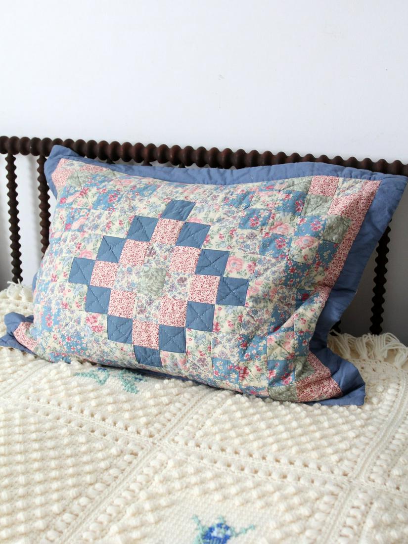 Vintage Quilted Pillow Sham: Vintage Quilted Pillow Sham This is a vintage quilted pillow case. The decorative pillow cover features a Trip Around the World quilt pattern in floral blues and pinks. Simple cotton backing with fold