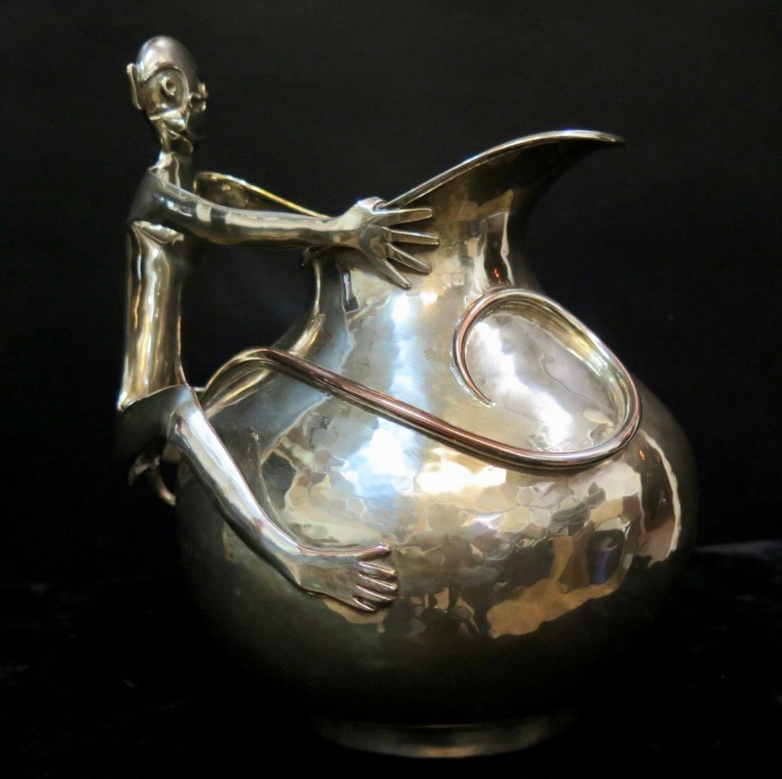 Vintage Maria Castillo Figural Monkey Water Pitcher: Vintage Maria Castillo Figural Monkey Water Pitcher This whimsical mid 20th century hand crafted silver plated copper water pitcher is designed with an applied sculpted figural handle. The handle is t