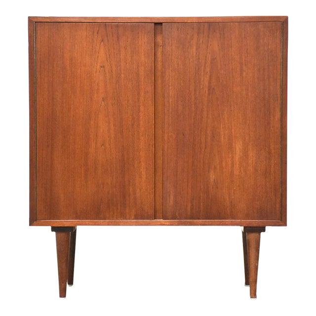 Danish Teak Credenza Cabinet: Danish Teak Credenza Cabinet A mid century modern teak credenza cabinet with tapered legs and shelving space. Made in Denmark. 31" wide. 16" deep. 34.25" tall. Dimensions: 31"W x 16"D x 34.25"H Styles