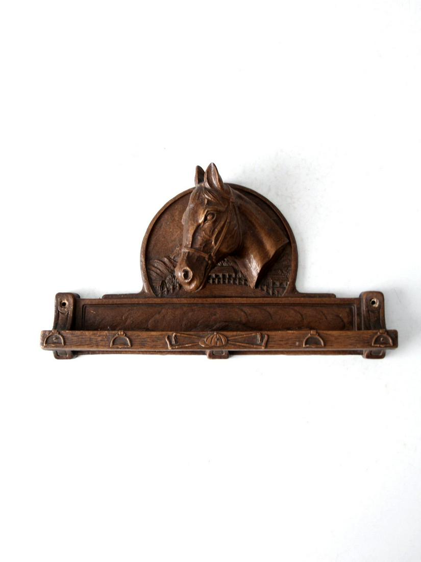 Vintage Syroco Style Equestrian Wall Shelf: Vintage Syroco Style Equestrian Wall Shelf This is a vintage Syroco equestrian wall hanging. The cast wooden shelf pictures a horse bust atop a "trough" like shelf with classic equestrian motif adornm