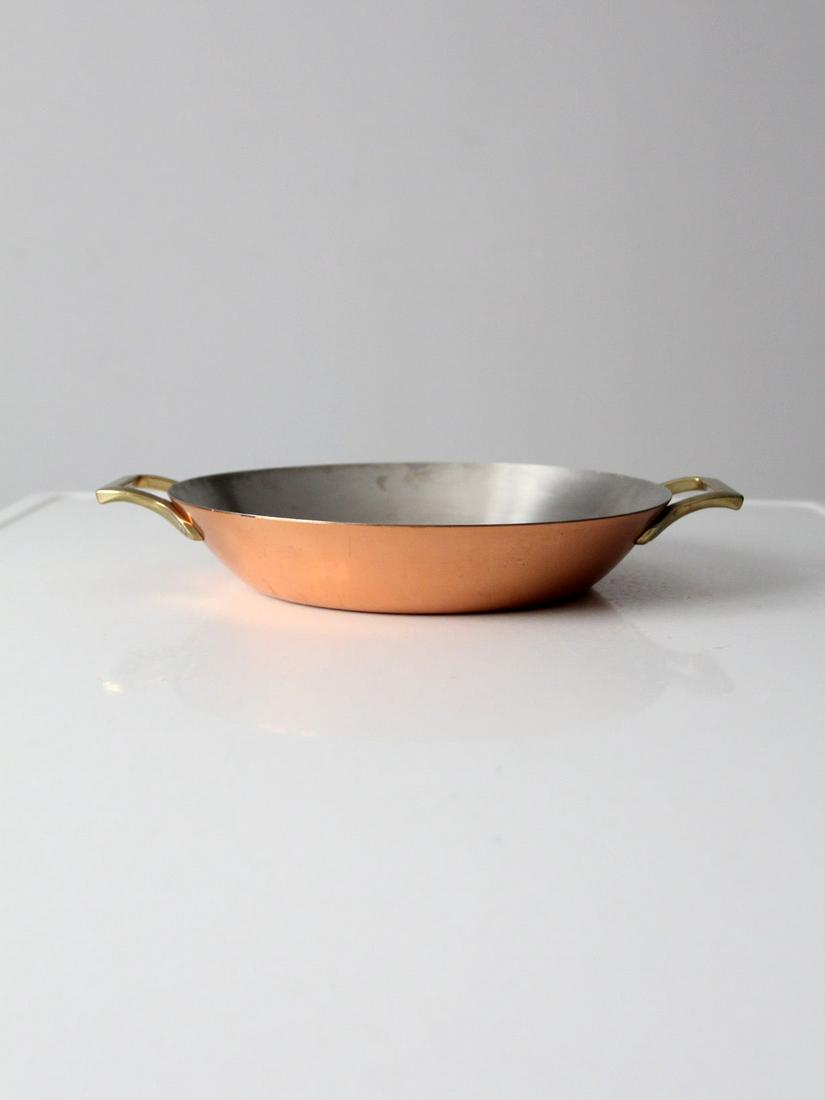 Vintage Paul Revere Copper Pan: Vintage Paul Revere Copper Pan This is a vintage Paul Revere Limited Edition copper pan. The classic saute pan features double brass handles and stainless steel lining. Width 13 inch 33 cm Depth 10.5 