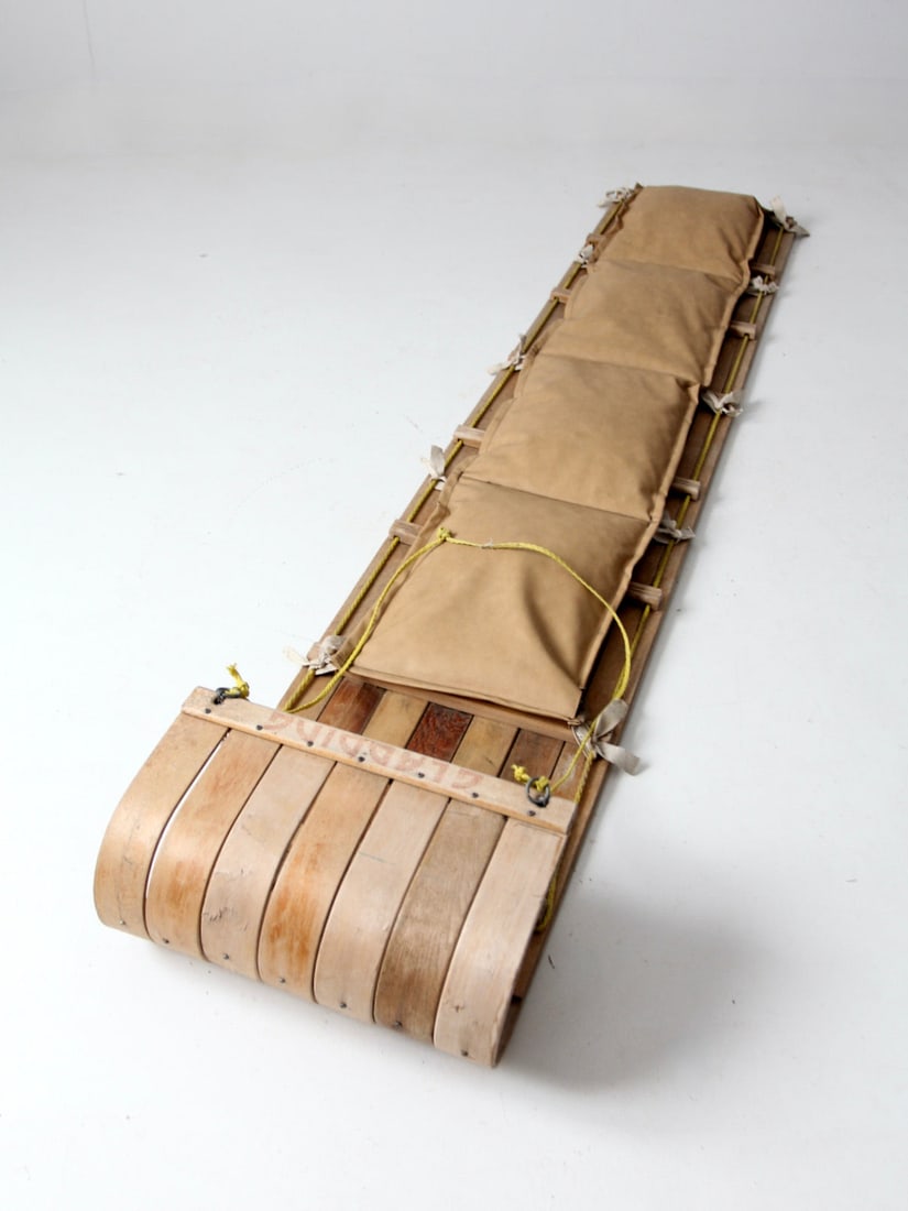Vintage Gladding Toboggan: Vintage Gladding Toboggan This is a vintage Gladding toboggan. The rare sized long toboggan sled is slat wood with an original faux leather cushion seating. Length 93.5 in 2.37 m Width 18 inch 45.7 cm