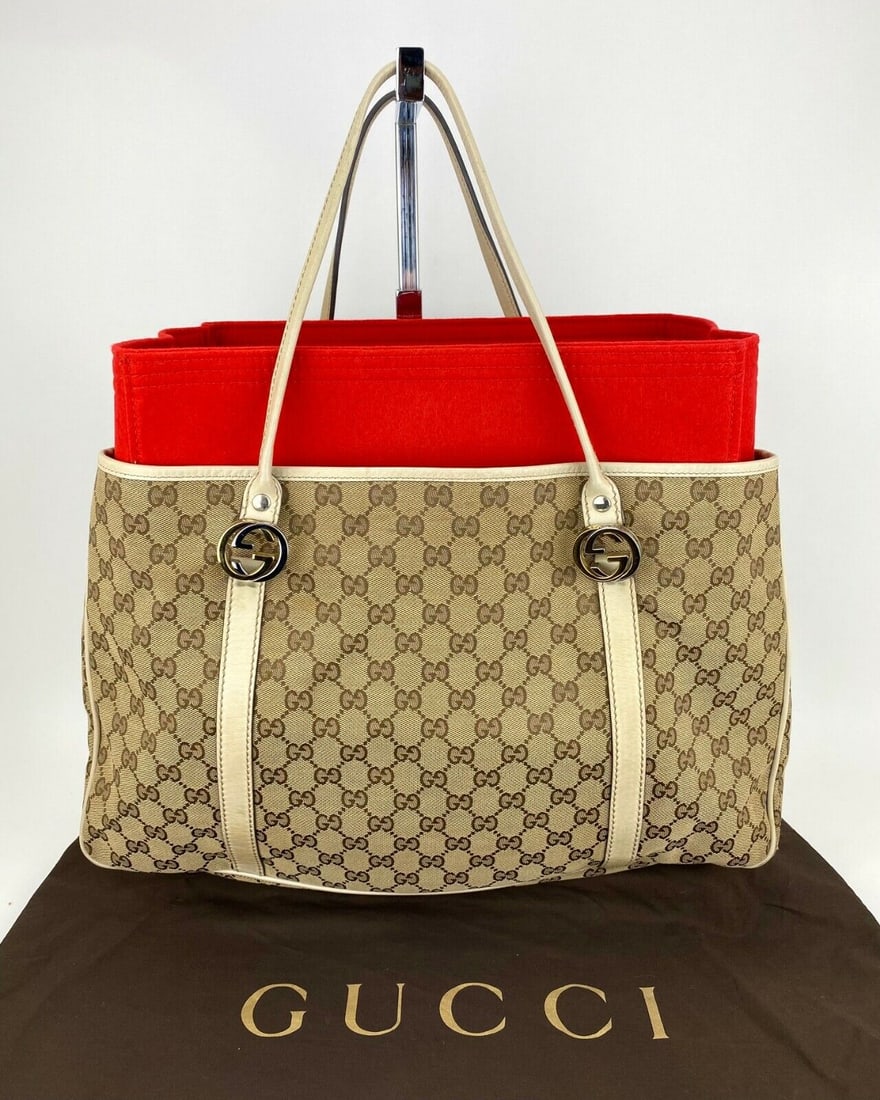 Gucci Womans Bag Monogram Large GG Twins Tote Off White W/Organizing Insert: Gucci Womans Bag Monogram Large GG Twins Tote Off White W/Organizing Insert Bag Width: 17 in Shape: Rectangle Closure: Snap Handle/Strap Color: Beige Size: Large Handle Drop: 12 in Hardware Color: Gol