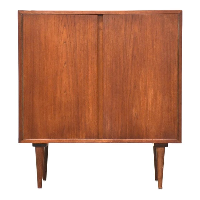 Danish Teak Credenza Cabinet: Danish Teak Credenza Cabinet A mid century modern teak credenza cabinet with tapered legs and shelving space. Made in Denmark. 31" wide. 16" deep. 34.25" tall. Dimensions: 31"W x 16"D x 34.25"H Styles
