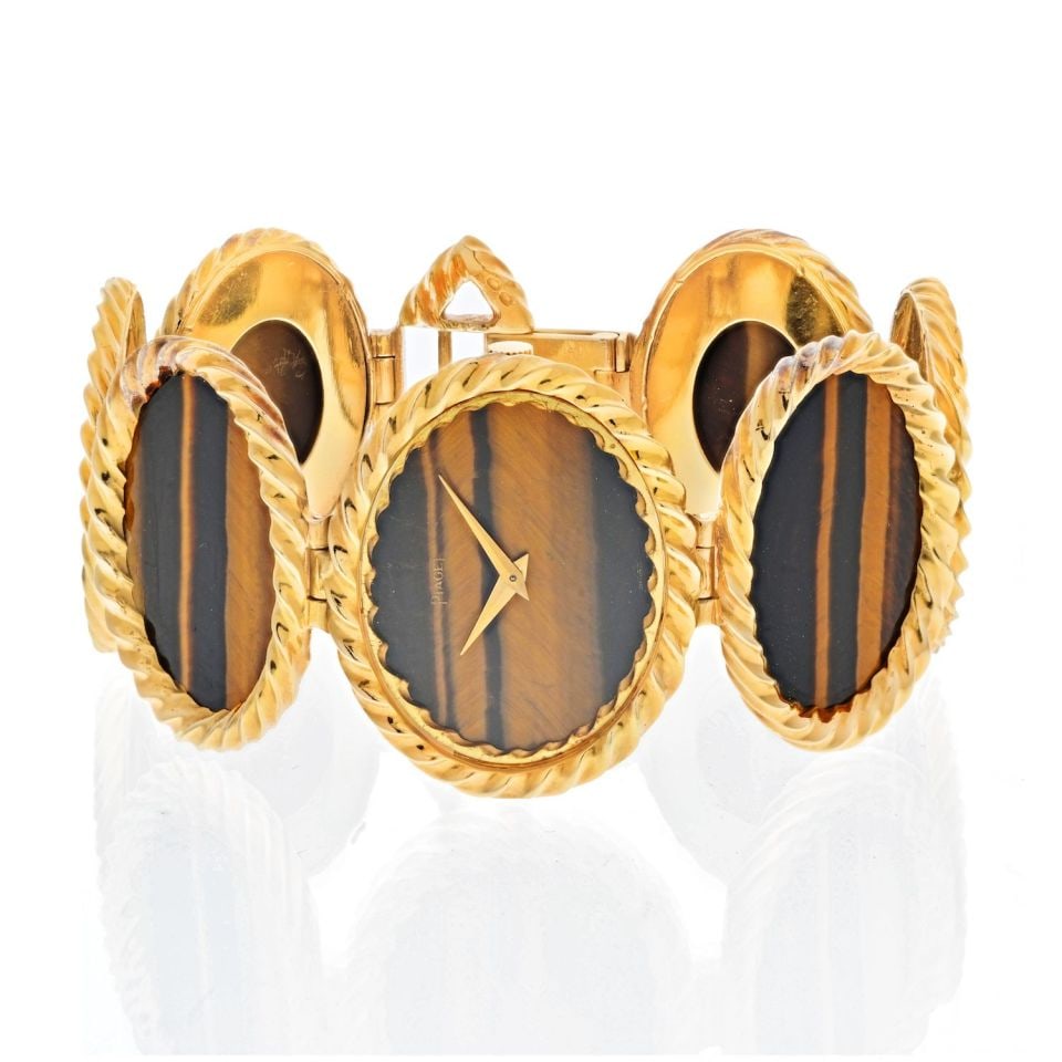 Piaget 18K Yellow Gold 1970's Tiger Eye Oval Link Watch: Piaget 18K Yellow Gold 1970's Tiger Eye Oval Link Watch Type: Vintage Watches Metal: 18K Yellow Gold Grams: 76.5 Measurements: L: 7.5 inches Condition: Excellent. Signed By: Piaget Brand: Piaget Other