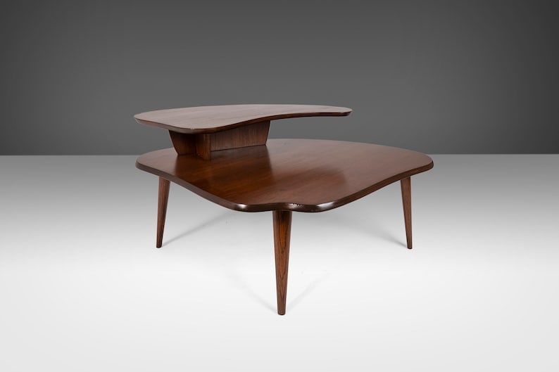 Mid Century Two-Tiered Coffee Table In Oak Stained Walnut After Paul Laszlo C. 1960S: Mid Century Two-Tiered Coffee Table In Oak Stained Walnut After Paul Laszlo C. 1960S Mid Century Two-Tiered Coffee Table in Oak Stained Walnut after Paul Laszlo c. 1960s About: An exceptional build. D