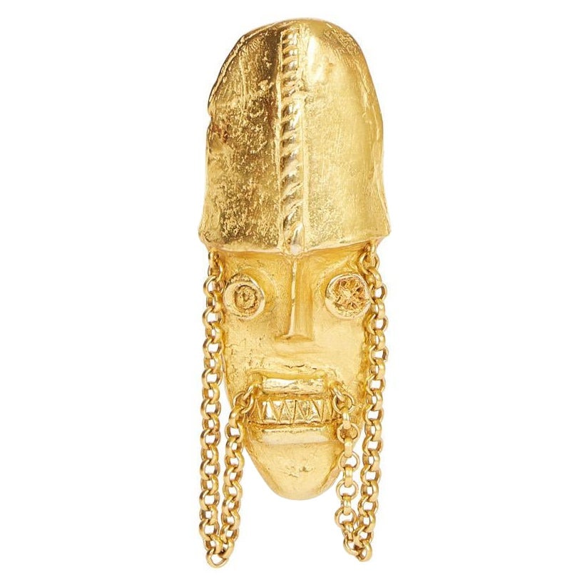 DKNY 90s Totem Mask Pin Brooch: DKNY 90s Totem Mask Pin Brooch Designer: Donna Karan Brand: Donna Karan Dimensions: Height: 3.5 in (8.89 cm)Width: 1.25 in (3.18 cm) Place of Origin: United States Period: 1990-1999 Pre-Owned The BIDH