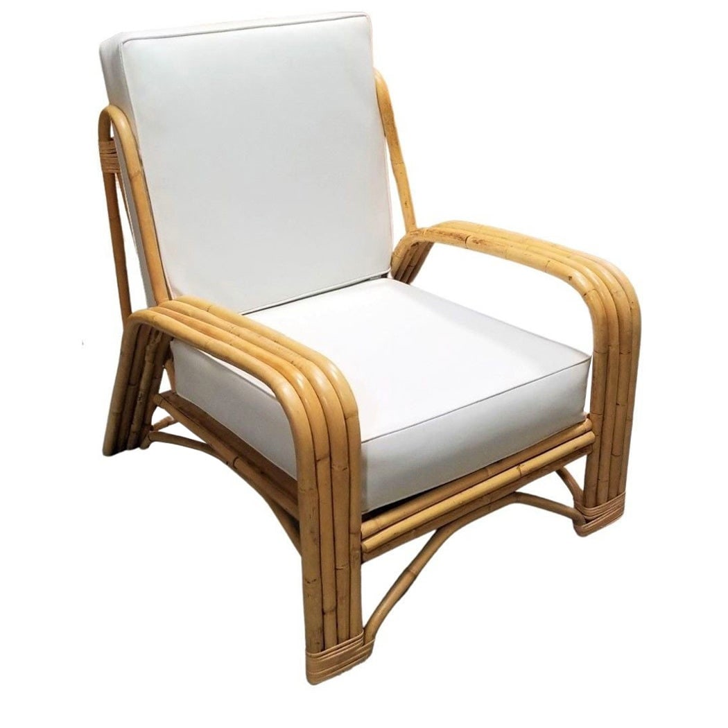 Restored 4-Strand Staple Arm Rattan Lounge Chair by Paul Laszlo: Restored 4-Strand Staple Arm Rattan Lounge Chair by Paul Laszlo Dimensions: Height: 31 in (78.74 cm)Width: 30 in (76.2 cm)Depth: 37 in (93.98 cm) Materials and Techniques: Rattan Period: 1950-1959 Dat