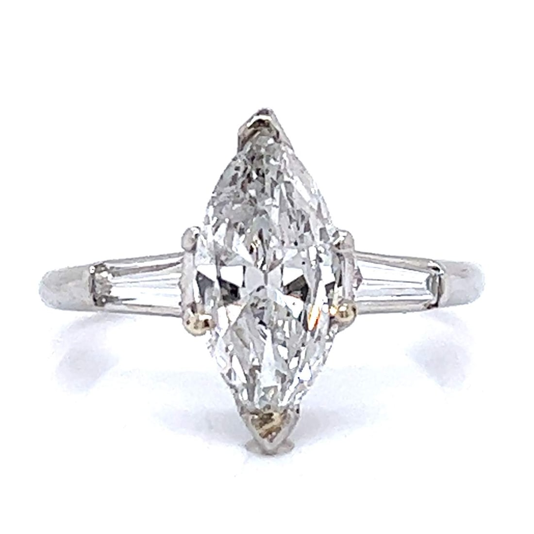 1950's Platinum 1.60 Ct. Diamond Ring: 1950's Platinum 1.60 Ct. Diamond Ring 1950's Platinum 1.60 Ct. Diamond Ring Weighing 5.6 grams Set with an app. 1.60 Ct. Marquise Diamond in Center D-E Color, I1 Clarity Along with 2 Baguette Diamonds
