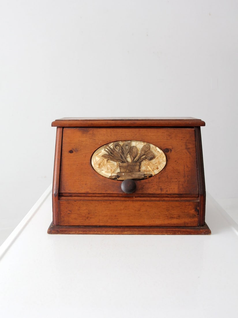 Vintage Wooden Bread Box: Vintage Wooden Bread Box This is a vintage wood bread box. The wooden box features an inlay oval tile on its door picturing wooden spoons with a natural straw backdrop. Width 17 inch 43.2 cm Depth 11