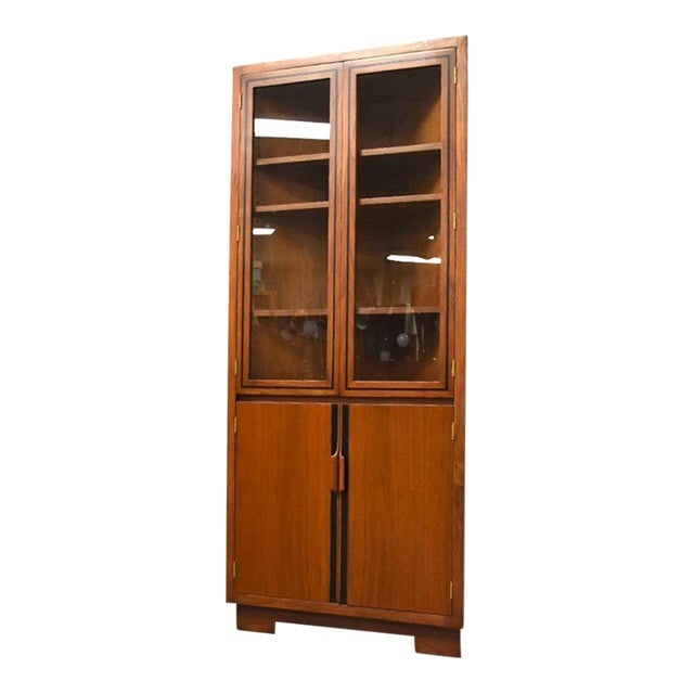 John Kapel Walnut Corner Cabinet: John Kapel Walnut Corner Cabinet A rare walnut corner cabinet designed by John Kapel for Glenn of California with sculpted walnut pulls and black accents. 33" wide. 16.75" deep. 75" tall. Dimensions: